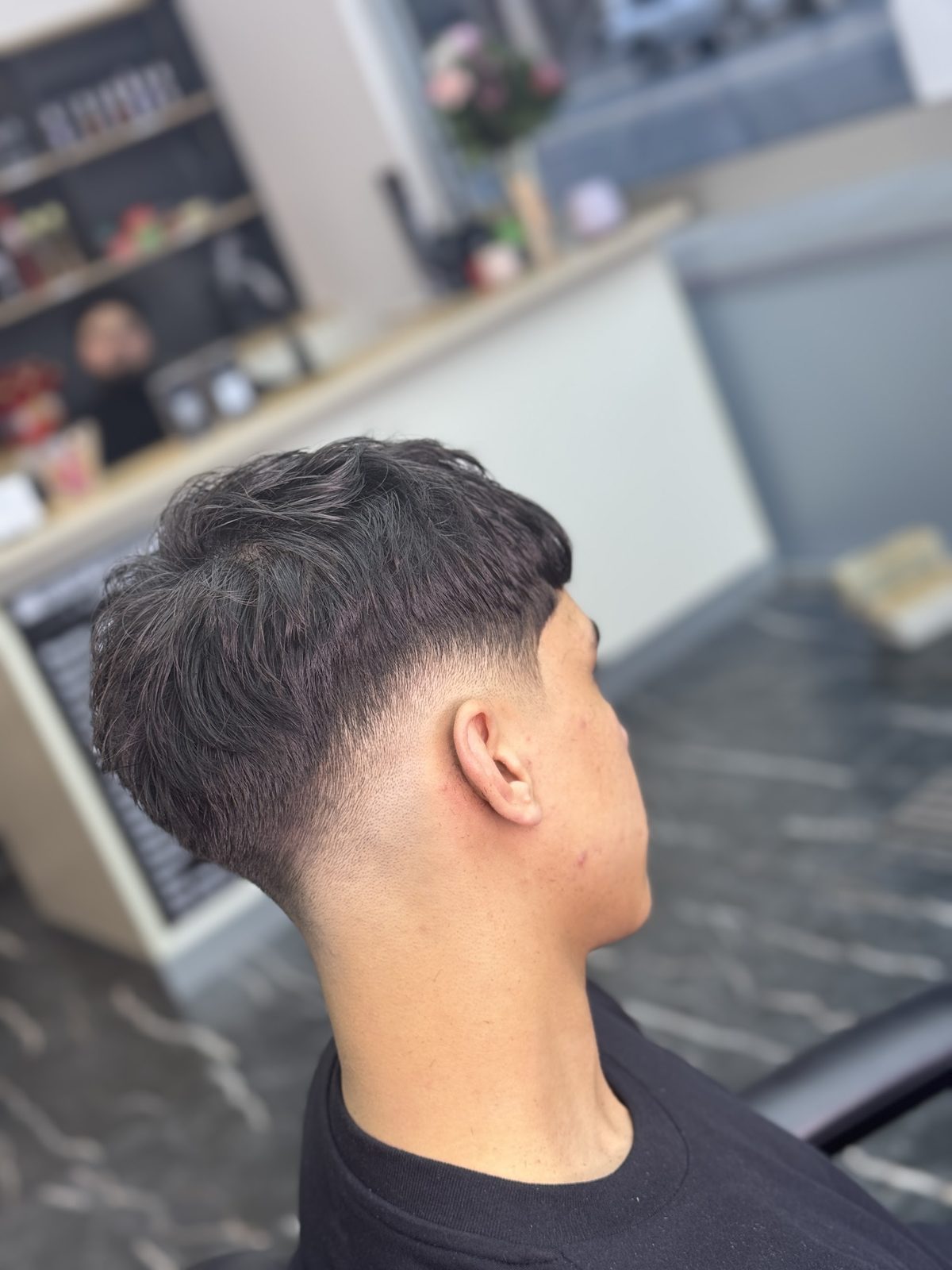 Back view of a low taper with a soft, messy top